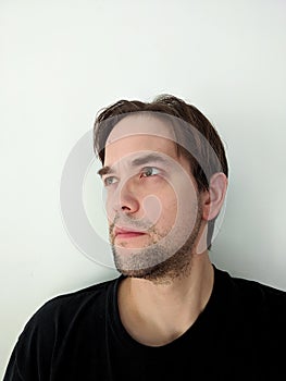 Portrait of Ambivalent Young Man Against White Background