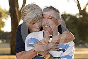 Portrait of American senior beautiful and happy mature couple around 70 years old showing love and affection smiling together in t