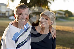 Portrait of American senior beautiful and happy mature couple around 70 years old showing love and affection smiling together in t