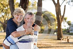 Portrait of American senior beautiful and happy mature couple around 70 years old showing love and affection smiling together in t