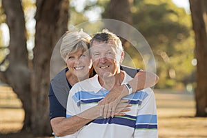 Portrait of American senior beautiful and happy mature couple around 70 years old showing love and affection smiling together in t