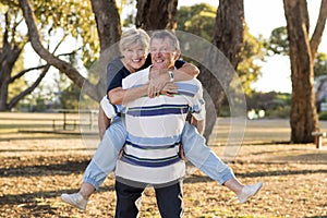 Portrait of American senior beautiful and happy mature couple around 70 years old showing love and affection smiling together in t