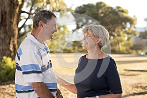 Portrait of American senior beautiful and happy mature couple around 70 years old showing love and affection smiling together in t