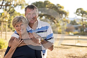 Portrait of American senior beautiful and happy mature couple around 70 years old showing love and affection smiling together in t