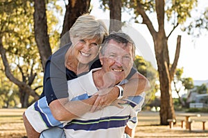 Portrait of American senior beautiful and happy mature couple around 70 years old showing love and affection smiling together in t