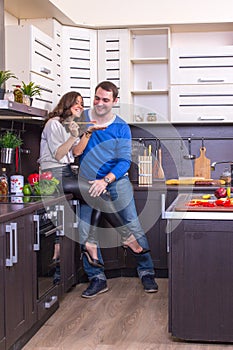Portrait Of Amorous Couple With food In The Kitchen