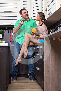 Portrait Of Amorous Couple With food In The Kitchen