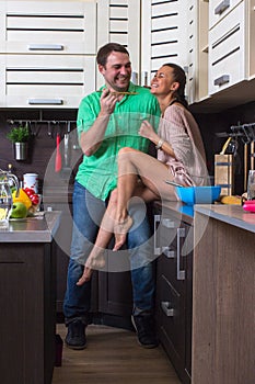 Portrait Of Amorous Couple With food In The Kitchen