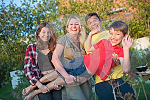 Portrait of amusing family at backyard