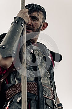 Portrait of ancient Spartan warrior in armor with spear