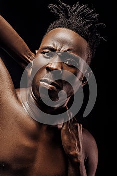 Portrait of African-American man on black background