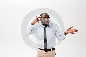 Portrait of angry or annoyed young African American man in white polo shirt looking at the camera with displeased