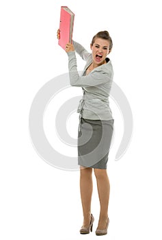 Portrait of angry business woman throwing folder