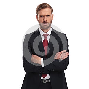 Portrait of angry businessman with folded arms standing