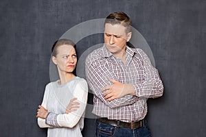 Portrait of angry couple looking with displeasure at each other