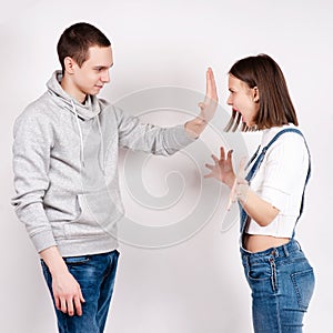 Portrait of an angry couple shouting each other against white background