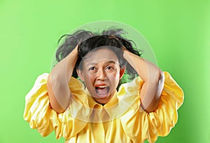 Portrait of angry crazy woman isolated on green screen background