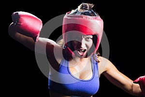 Portrait of angry female boxer with fighting stance