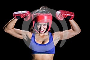 Portrait of angry female boxer flexing muscles