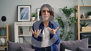 Portrait of angry girl looking at camera, shouting and flapping arms with anger