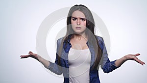 Portrait of angry long-haired woman negatively shaking head saying no waving hands in denial over white background