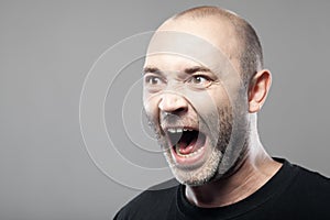 Portrait of angry man sreaming isolated on gray background