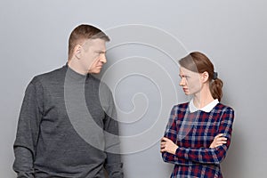 Portrait of angry man and woman looking with grudge at each other