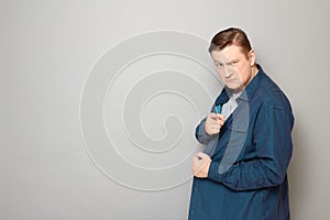 Portrait of angry mature man pointing with index finger at you