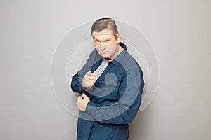 Portrait of angry mature man pointing with index finger at you