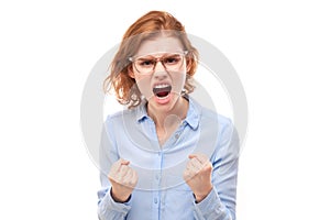 Portrait angry redhead young woman screaming isolated on white studio background, showing negative