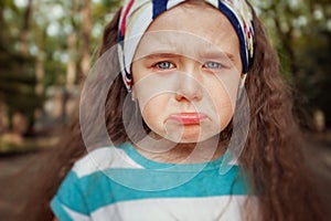 Portrait of angry and sad little girl. Children`s emotions