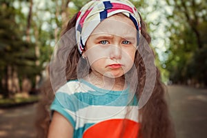 Portrait of angry and sad little girl. Children`s emotions