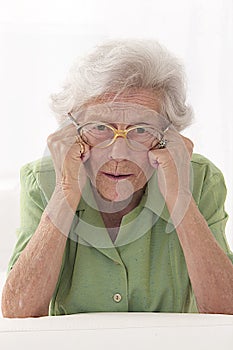 Portrait of an angry senior lady with eyes glasses
