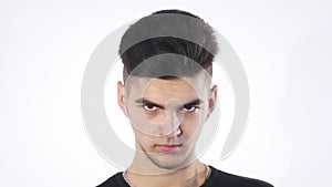 Portrait of angry serious young man, boy isolated over white background, concept problem worried teenager student