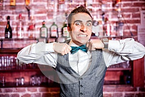 Portrait of angry and stressed bartender or barman with bowtie photo