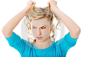 Portrait of angry woman pulling her hair