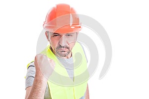 Portrait of angry worker showing his fist