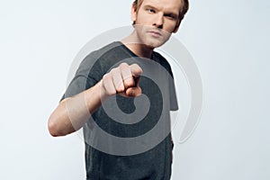 Portrait of Angry Young Man Pointing Forefinger photo