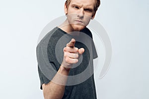 Portrait of Angry Young Man Pointing Forefinger photo