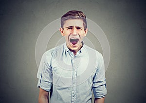 Portrait of an angry young man screaming