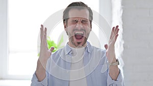 Portrait of Angry Young Man Screaming in Frustration