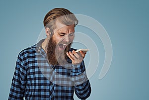 Angry young man screaming on mobile phone