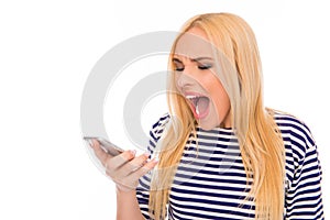 Portrait of angry young woman screaming on her mobile phone