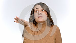 Portrait of annoyed and strssed woman making wtf hand gesture over white studio background