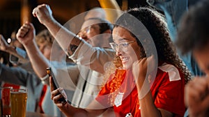 Portrait of an Anxious Multiethnic Female in Red Jersey Using a Smartphone, Nervous About the Sports