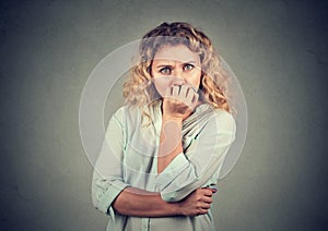 Portrait anxious woman biting her fingernails craving for something