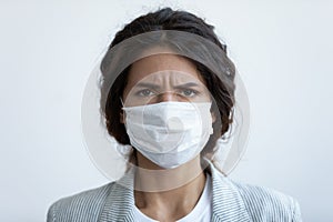 Portrait of anxious woman in medical mask worried of pandemic