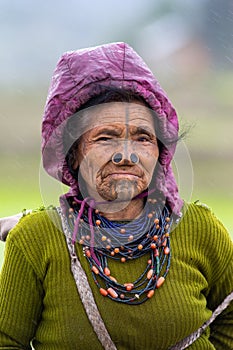 The portrait of Apatani women with her nose plug and tattoos.