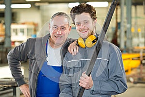 Portrait apprentice and engineer in factory