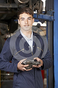 Portrait Of Apprentice Mechanic In Auto Repair Shop